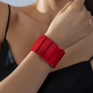 Modern wide red acrylic elastic bracelet with marble texture worn on woman wrist