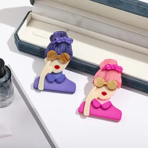 Detailed macro view of stylish acrylic flower brooches with artistic portrait design