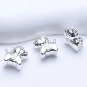 Macro shot of silver zodiac horse beads with polished mirror finish and H logo engraving