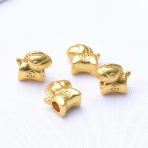Macro detail of horse-shaped golden zodiac beads with ancient coin relief for DIY jewelry