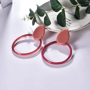 Pink geometric resin hoop earrings with round acrylic acetate rings in minimalist style
