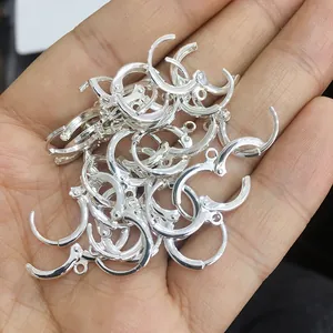 Gros plan de dormeuses rondes en argent poli pour la création de bijoux DIY
