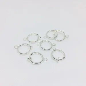Detailed view of six silver spring clip earrings with small loops for jewelry making