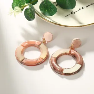 Pink and cream contrast acetate hoop earrings with marble texture and golden metal links