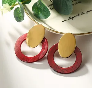 Vintage style gold oval stud earrings with deep red acetate marble rings