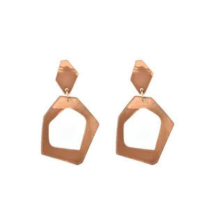 Modern geometric earrings featuring reddish brown acetate and acrylic resin shapes
