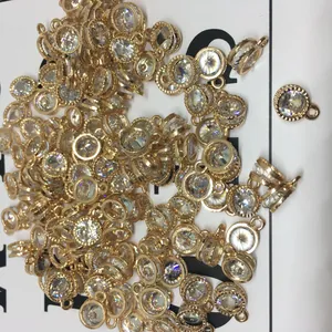 Macro shot of gold alloy heart charms with sparkling zircon inlay for DIY jewelry crafts