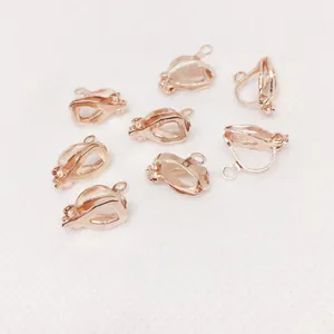 Close-up of eight rose gold triangular clip-on earring converters for non-pierced ears