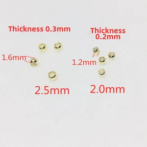 Macro view of 14k gold-filled crimp beads in 2.0mm and 2.5mm sizes for DIY jewelry making