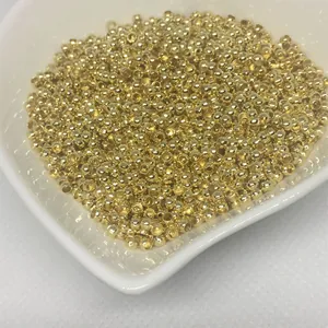 Detailed view of 14k gold-filled crimp beads for DIY jewelry making on white dish
