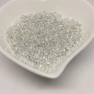Macro view of silver loose spacer beads in a heart-shaped bowl for jewelry making