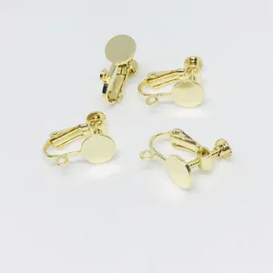Detail view of four gold-plated screw-back earring converters for DIY jewelry making