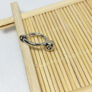 Detailed view of silver-plated spring clip earrings converter on a natural bamboo mat
