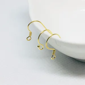 Macro view of gold-plated S925 sterling silver ear hooks showing detailed metal engraving