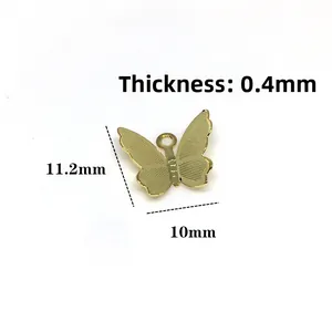 Macro detail of 14k gold butterfly charm with mesh texture for DIY jewelry making