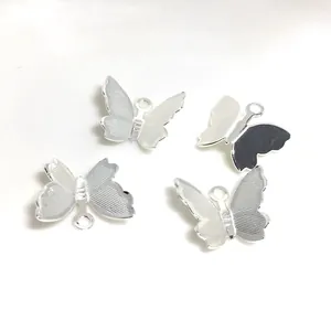 Detailed macro view of four silver 3D butterfly pendants with mesh texture for DIY jewelry