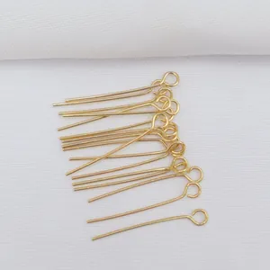 Macro shot of 14k gold-filled eye pins for DIY jewelry making and handmade beading crafts