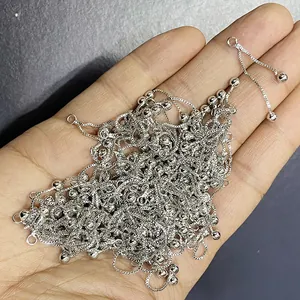 Close-up of silver box chain sliders with adjustable metal beads for DIY jewelry making