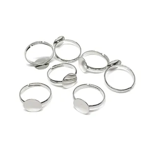 Detailed view of adjustable 14k gold-filled ring bases with 10mm flat round disc settings