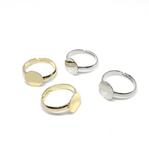 Close-up of gold and silver plated 10mm flat pad ring bases for DIY jewelry making