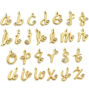 Macro shot of 14k gold-plated lowercase alphabet charms with micro-set zircon accents