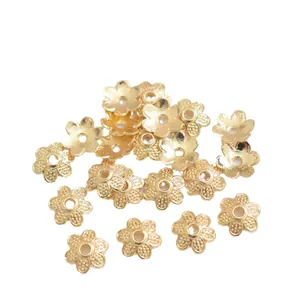 Golden flower-shaped 14k spacer beads for DIY jewelry making accessories on white background