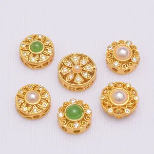 Detailed view of hollow floral spacers with pearls and emerald-green stones for DIY jewelry