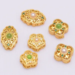 Macro shot of antique gold-plated filigree beads with pearl and zircon for DIY jewelry