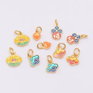 Detailed macro view of assorted gold-plated DIY jewelry pendants with colorful enamel
