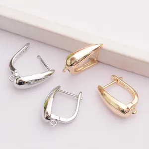 Macro view of 14k gold-plated droplet ear hooks with S925 hallmark detail