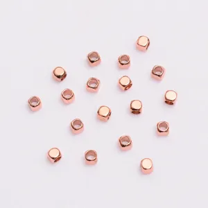 Detailed view of rose gold square spacer beads with holes for DIY jewelry making