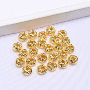 Close-up of 14k gold plated twisted hollow round spacer bead for DIY jewelry making