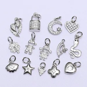 Macro view showing various silver cubic zirconia clover and heart charms for DIY jewelry making