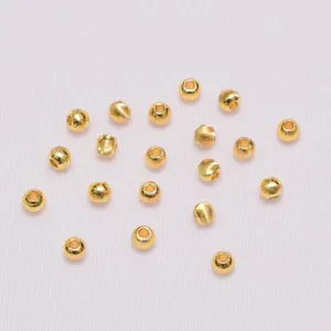 Macro detail of 18K gold-plated spacer beads with brushed texture for DIY jewelry making