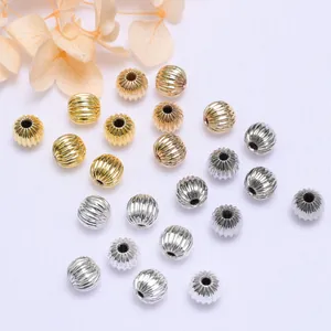 Macro detail of 18k gold plated melon ribbed spacer beads for DIY jewelry making