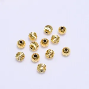 Detailed view of 18k gold plated hollow pumpkin beads for DIY jewelry making