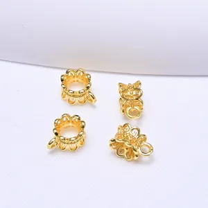 Macro shot of 4 gold hollow flower spacers with crown shape for DIY jewelry making