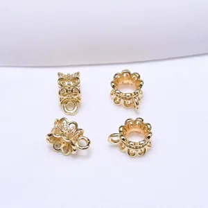 Close-up of four 18k gold-plated hollow lace spacer beads for DIY jewelry making