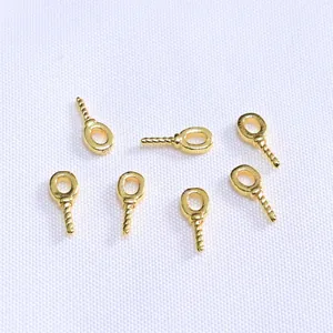 Detailed macro view of 18k gold plated screw eye pins for DIY jewelry making