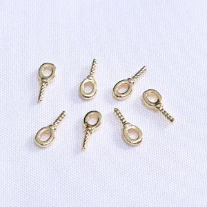 18k gold plated screw eye pins for DIY pearl pendants on white fabric background