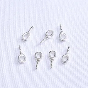 Detailed view of seven silver screw eye pins for DIY jewelry making and pearl pendants