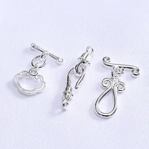Macro shot of 14K gold-plated OT toggle clasps with traditional Ruyi cloud patterns