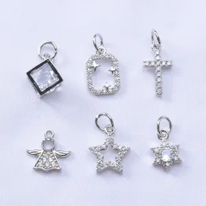 Macro shot of 14k gold-plated charms with micro-pave cubic zirconia star and heart shapes