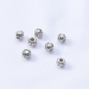 Macro view of 4.5mm silver hollow football beads with inlaid cubic zirconia for jewelry