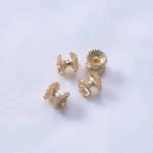 Macro detail of 14K gold plated irregular wave spacers with sparkling zircon accents