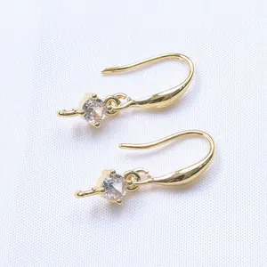 Detail of 14K gold plated earring hooks with sparkling zircon stones in a classic setting