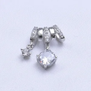 Polished silver charm set with micro-pave zircon rings and two clear gemstone pendants