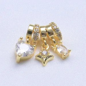 Macro shot of 14k gold-filled heart and star charms with micro-pave cubic zirconia