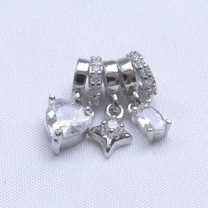 Macro shot of 14k gold-plated heart and star pendants with micro-pave cubic zirconia