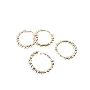 Classic 14k gold beaded circle hoop earrings with minimalist polished surface for women